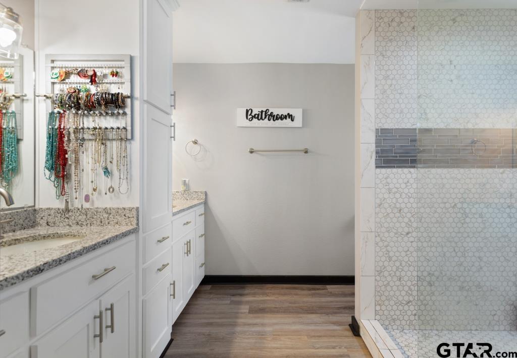 106 Ridgecrest Circle Bullard, TX 75757 - Photo 27 of 32 a bathroom with a granite countertop sink and a mirror