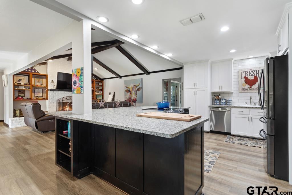106 Ridgecrest Circle Bullard, TX 75757 - Photo 10 of 32 a kitchen with stainless steel appliances granite countertop a sink a stove and a refrigerator