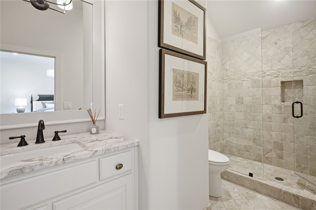 226 Long Ridge Road Sunset, SC 29685 - Photo 37 of 50 This bathroom features elegant marble countertops, a modern vanity, and a tiled walk-in shower.