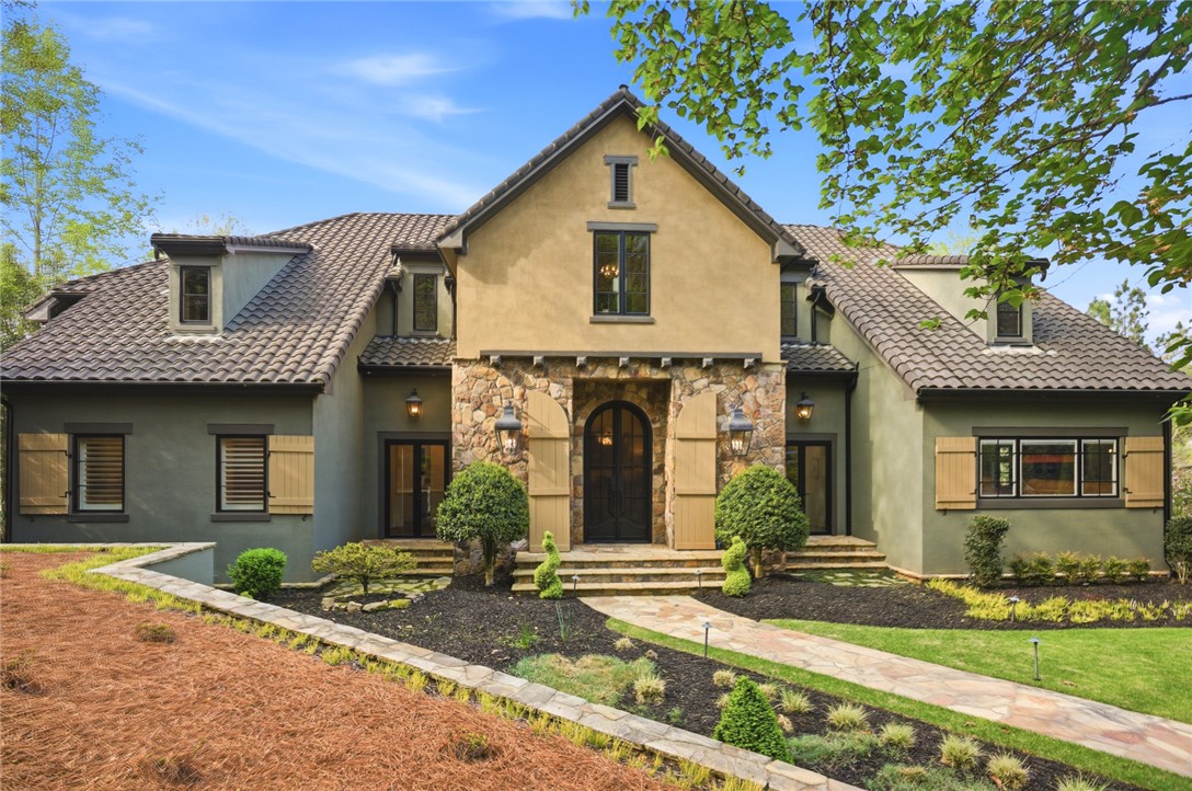 226 Long Ridge Road Sunset, SC 29685 - Photo 4 of 50 This home features a captivating facade with stone accents, stucco, and wood shutters.