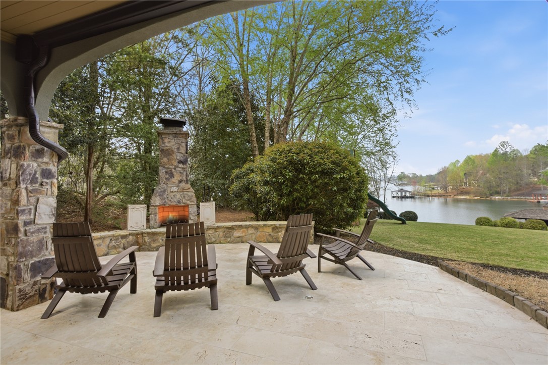 226 Long Ridge Road Sunset, SC 29685 - Photo 46 of 50 Enjoy the tranquil lakefront setting from this inviting patio, complete with an outdoor fireplace.
