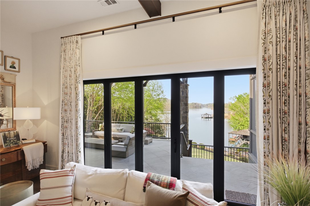 226 Long Ridge Road Sunset, SC 29685 - Photo 10 of 50 This living area offers serene water views from an expansive outdoor patio, perfect for relaxed enjoyment.