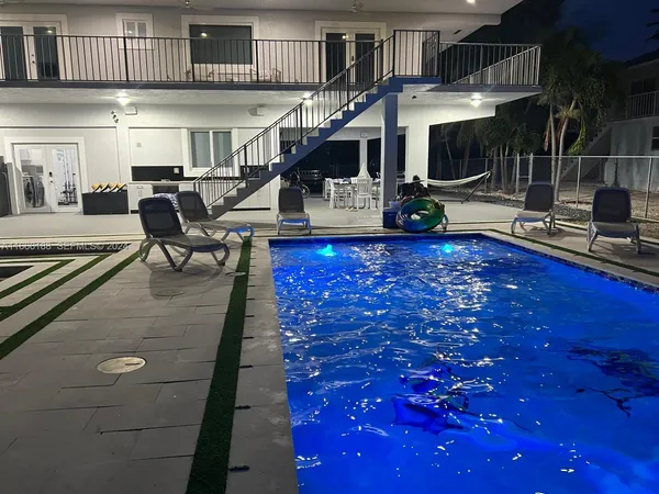 a view of a backyard with chairs and a swimming pool