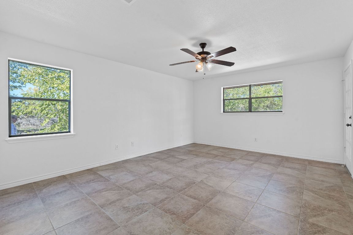 130 Meyers Road Buda, TX 78610 - Photo 11 of 35 a view of room with a ceiling fan and window