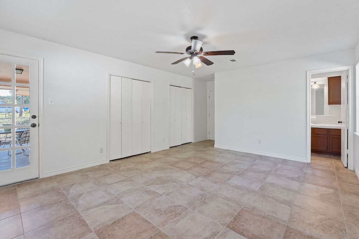 130 Meyers Road Buda, TX 78610 - Photo 12 of 35 a view of an empty room with a fan