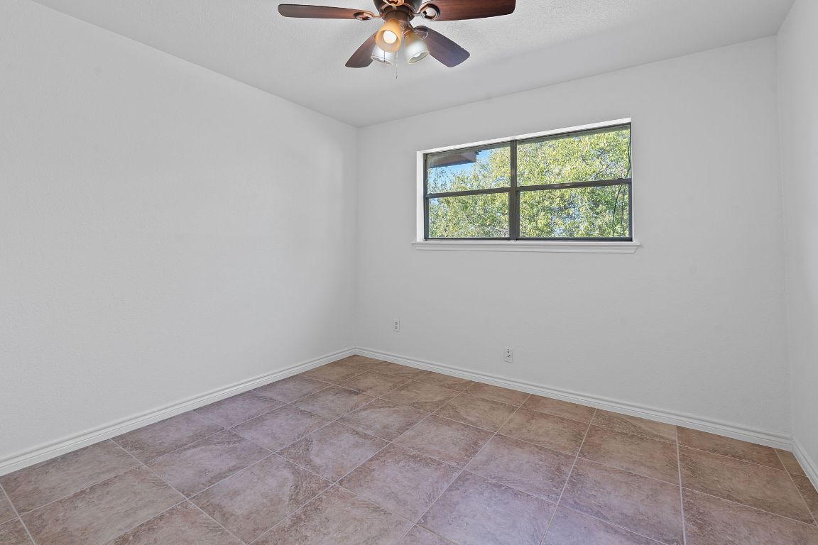 130 Meyers Road Buda, TX 78610 - Photo 16 of 35 an empty room with a window and a fan