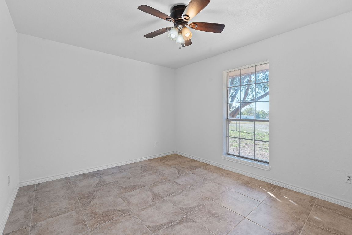 130 Meyers Road Buda, TX 78610 - Photo 18 of 35 an empty room with windows and fan