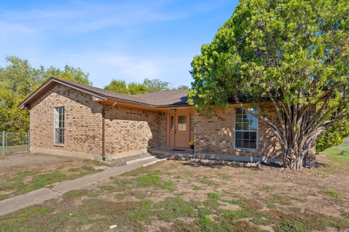 130 Meyers Road Buda, TX 78610 - Photo 24 of 35 a view of a house with yard and a tree