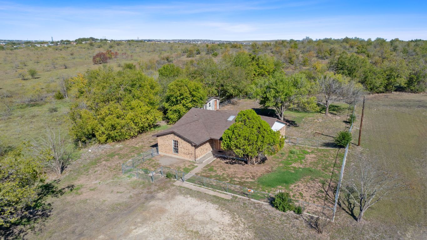 130 Meyers Road Buda, TX 78610 - Photo 34 of 35 an aerial view of green landscape with trees houses and mountain view