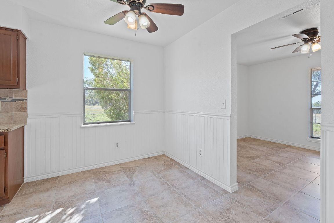 130 Meyers Road Buda, TX 78610 - Photo 10 of 35 an empty room with windows and fan