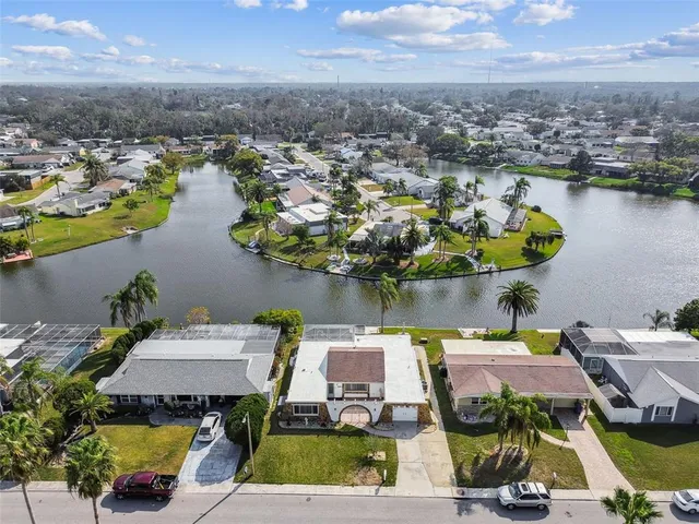 an aerial view of a house with swimming pool and ocean view