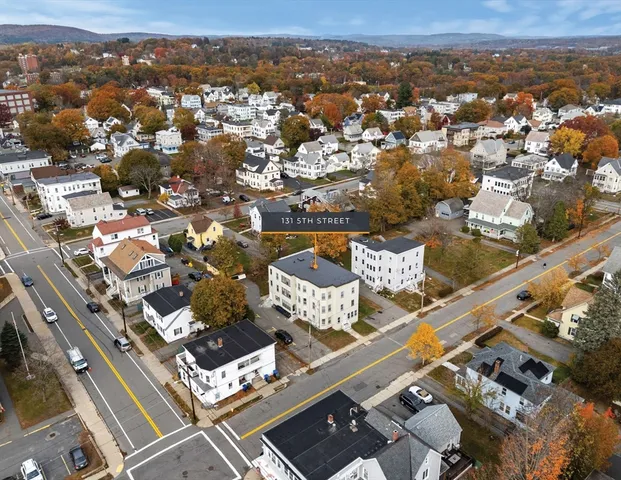 an aerial view of residential houses with outdoor space