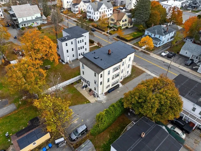 an aerial view of a house with a swimming pool