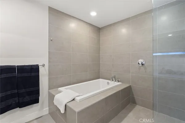 a bathroom with a bathtub and a shower