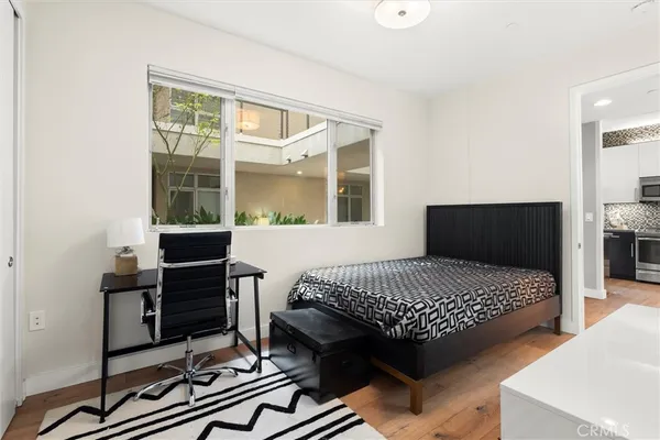 a bedroom with a bed and wooden floor