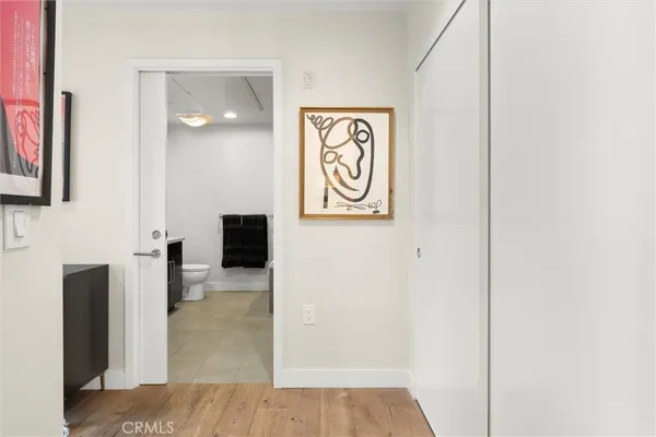 a view of a hallway with wooden floor