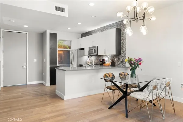 a kitchen with granite countertop a refrigerator and microwave