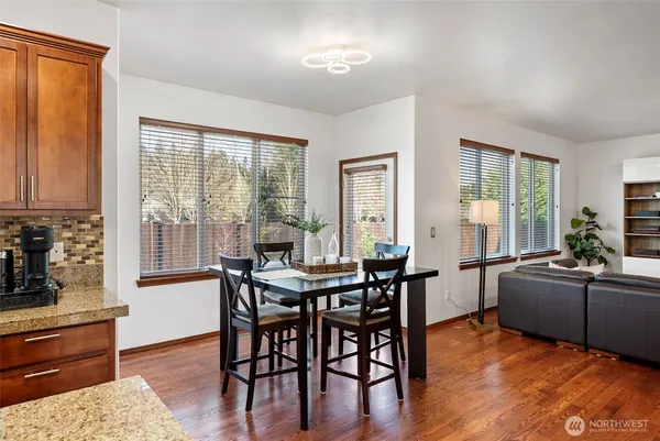 a view of a dining room with furniture window and wooden floor