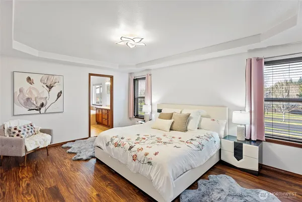 a bedroom with a bed and a painting on the wall
