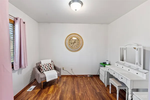 a view of room with furniture and wooden floor
