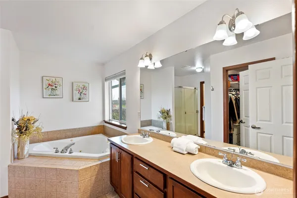 a bathroom with a granite countertop sink a large mirror and a