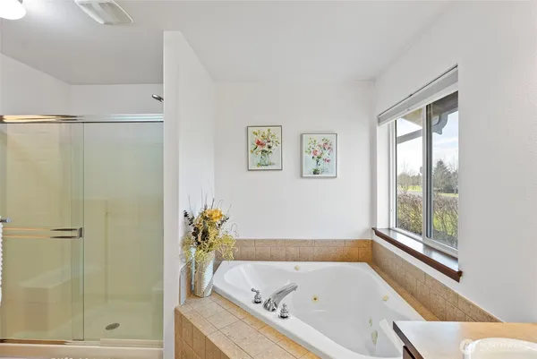 a bathroom with a tub and shower
