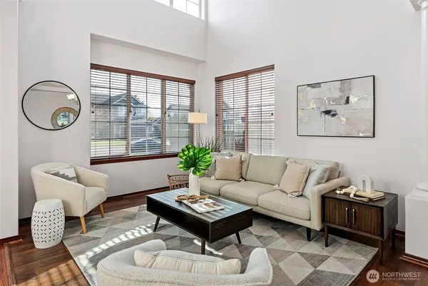 a living room with furniture a table and a large window