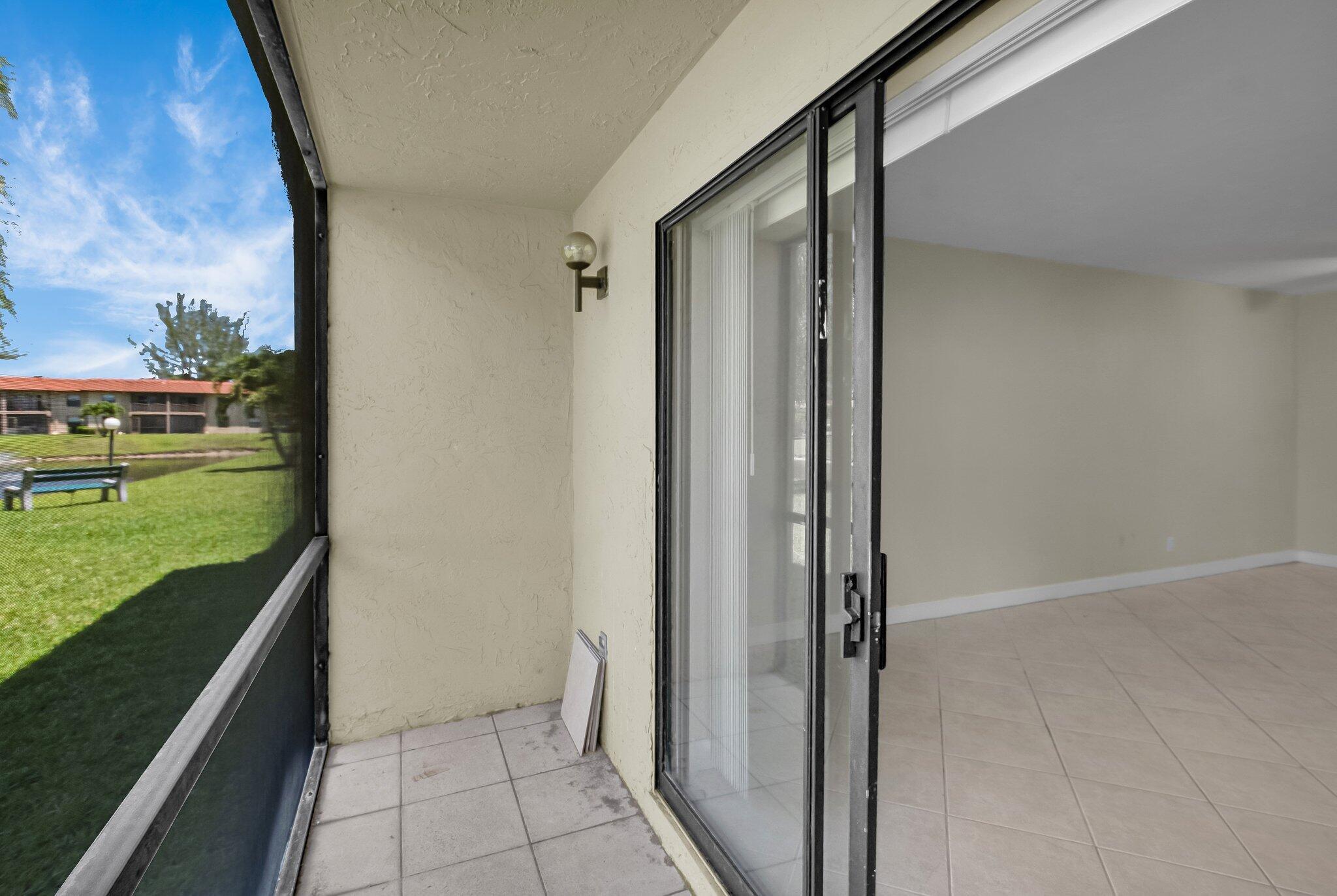 21911 Lake Forest Circle, Unit 103 Boca Raton, FL 33433 - Photo 14 of 24 Patio onto lake