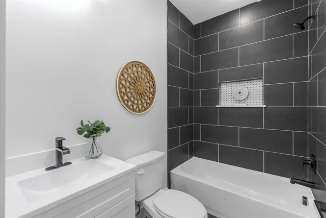 a bathroom with a toilet a sink and mirror