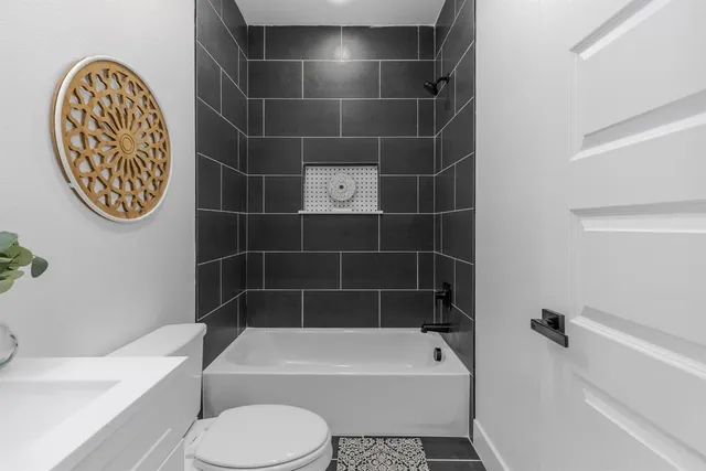 a bathroom with a toilet and a bathtub