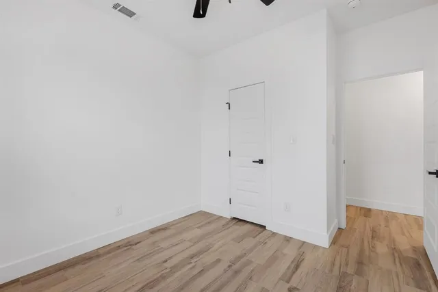 a view of a room with wooden floor