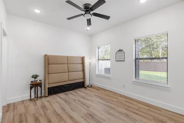 a view of a livingroom with a window and wooden floor