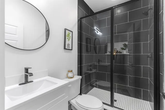 a bathroom with a sink toilet and shower