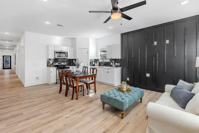 a living room with furniture and a wooden floor
