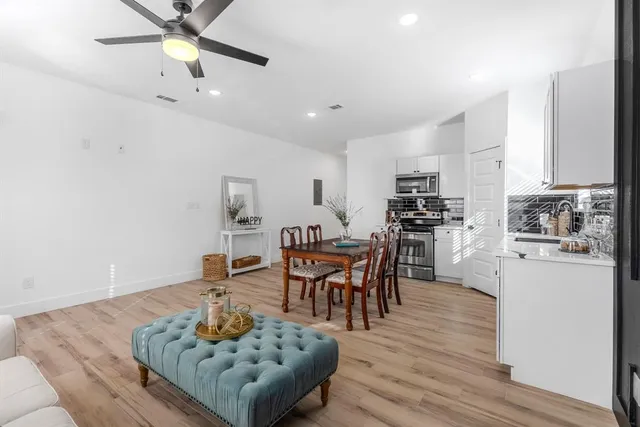 a living room with kitchen island furniture and a wooden floor