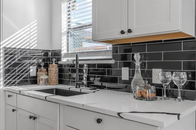 a kitchen with a sink and cabinets