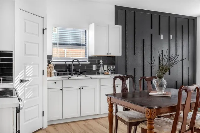 a kitchen with a sink cabinets and window