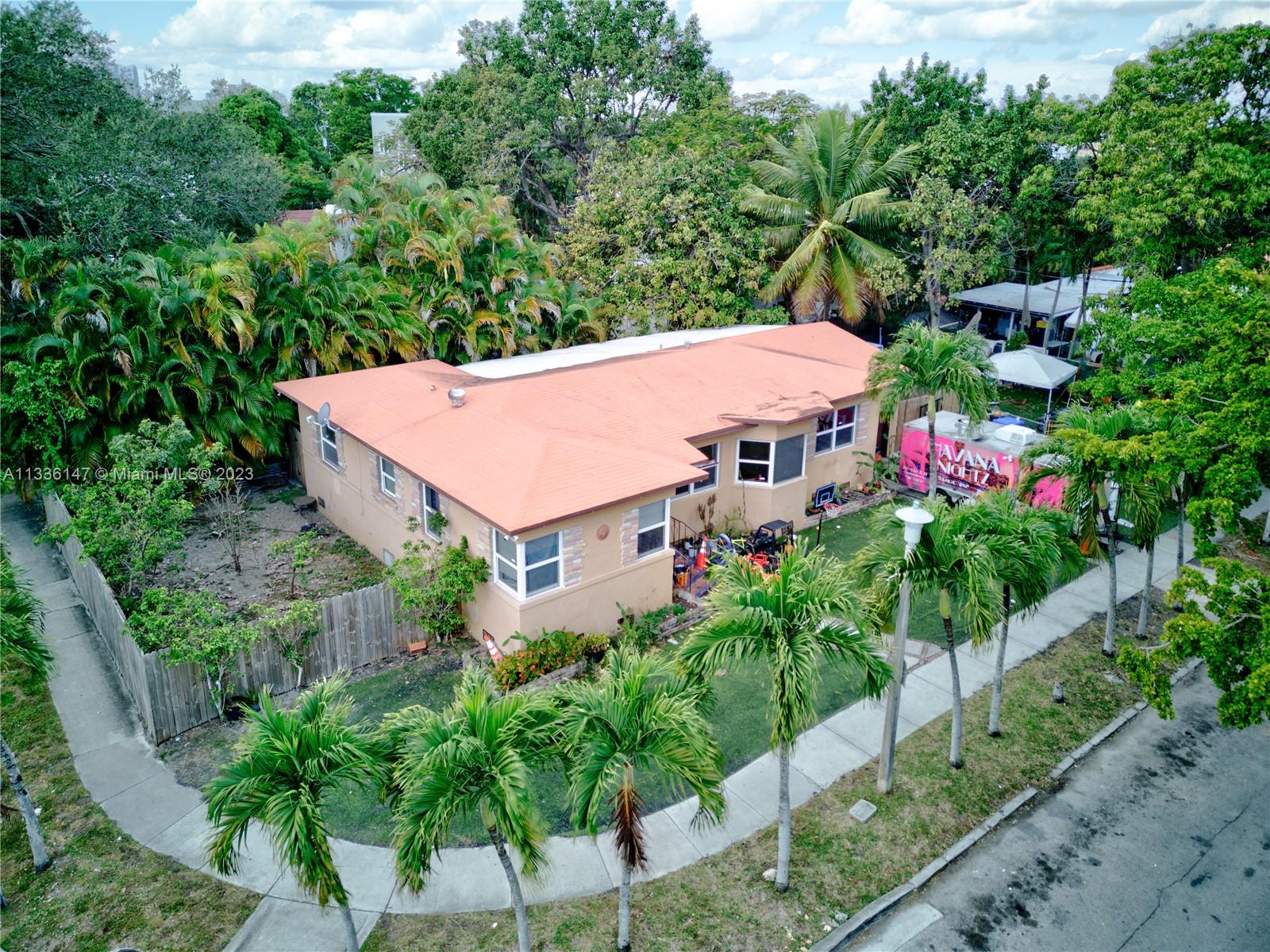 an aerial view of a house with balcony and garden