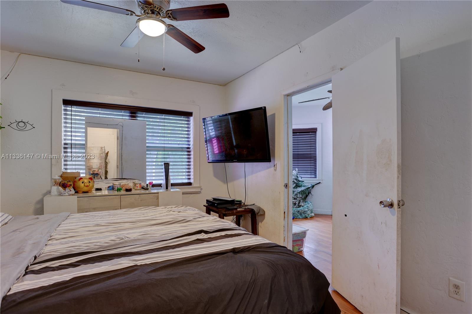 980 Southwest 15th Avenue Miami, FL 33135 - Photo 14 of 23 a bedroom with a bed and a flat tv screen on dresser