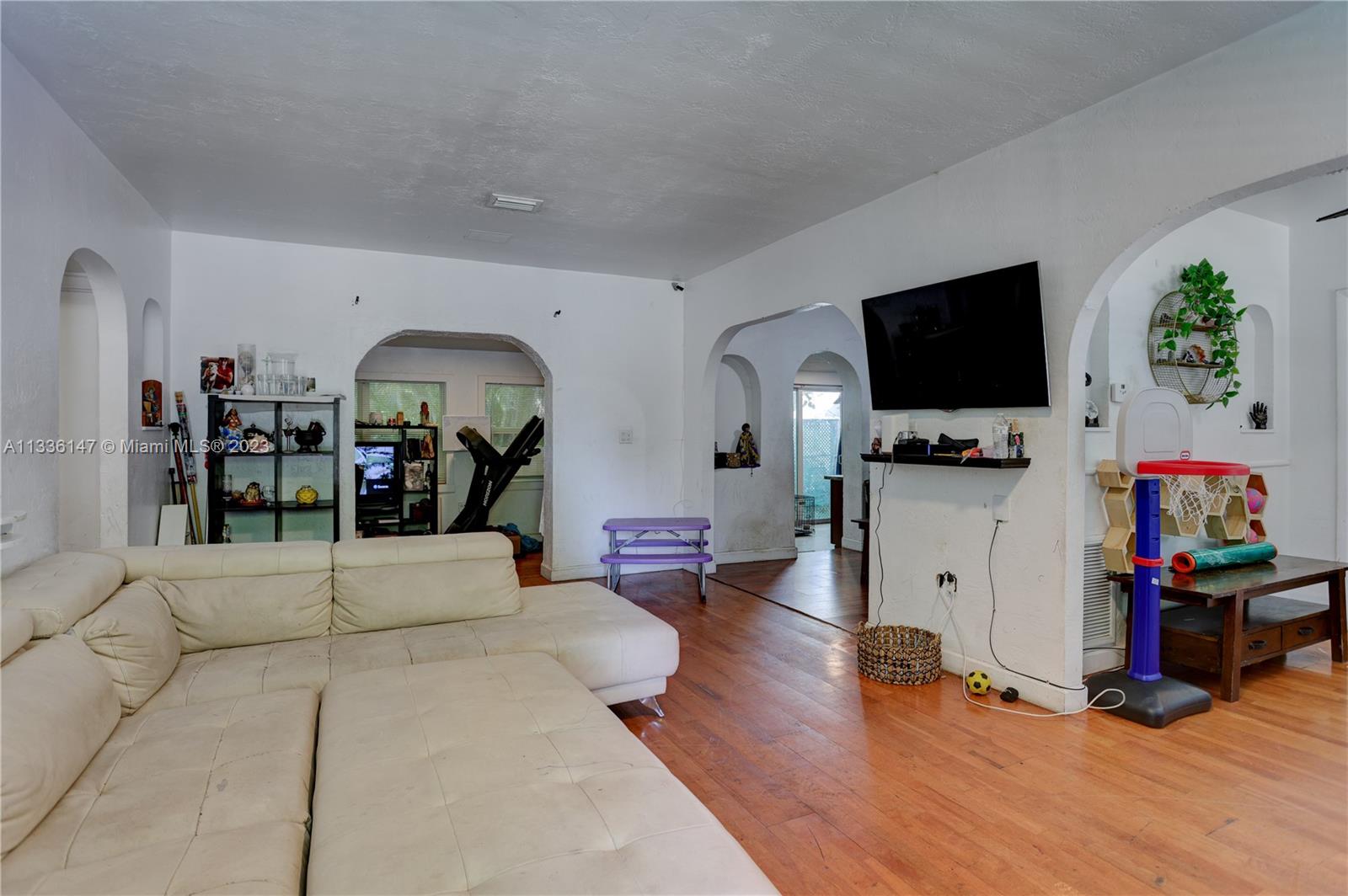 980 Southwest 15th Avenue Miami, FL 33135 - Photo 5 of 23 a living room with furniture and a flat screen tv