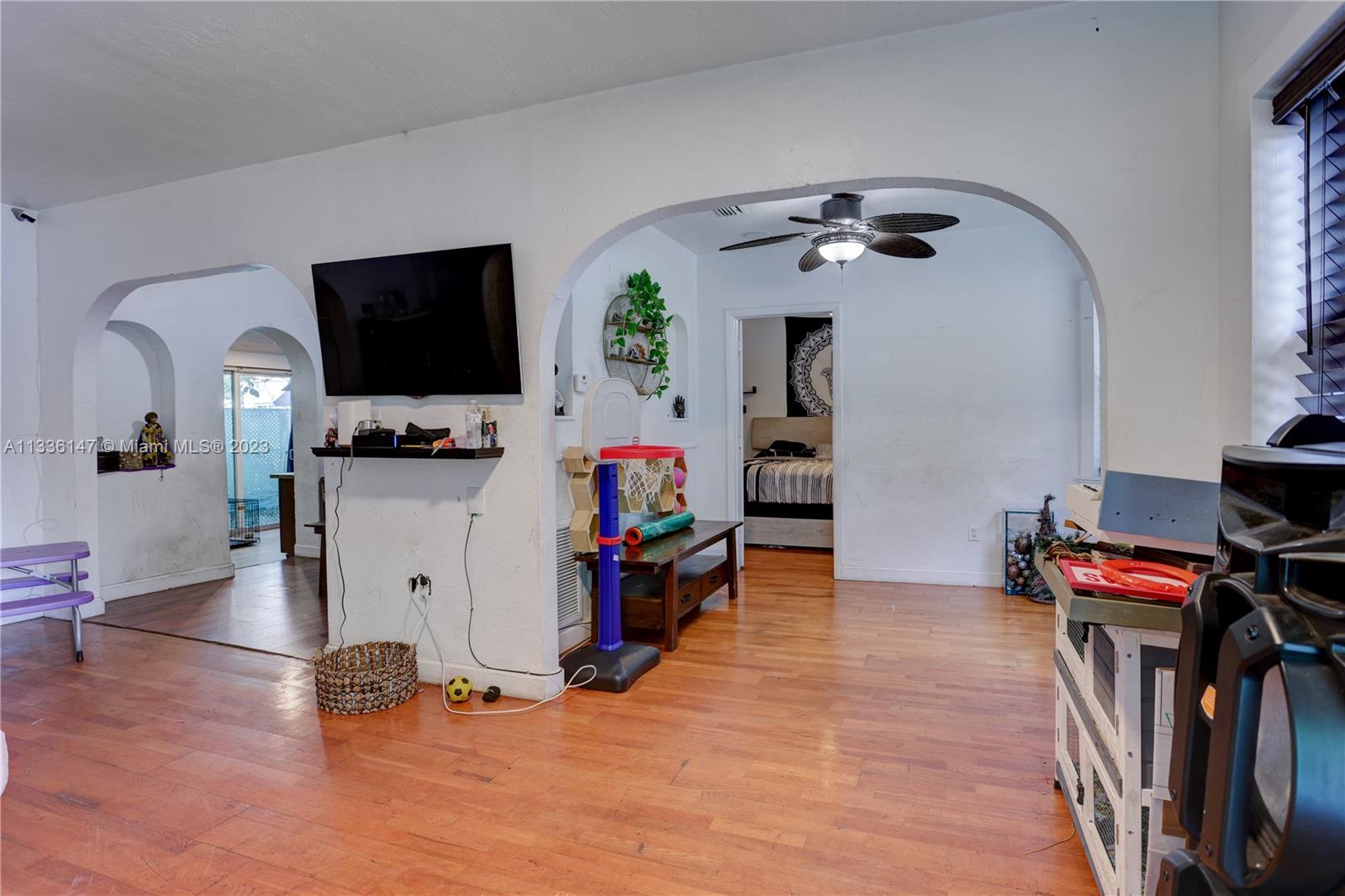 980 Southwest 15th Avenue Miami, FL 33135 - Photo 6 of 23 a view of a livingroom with furniture and a flat screen tv