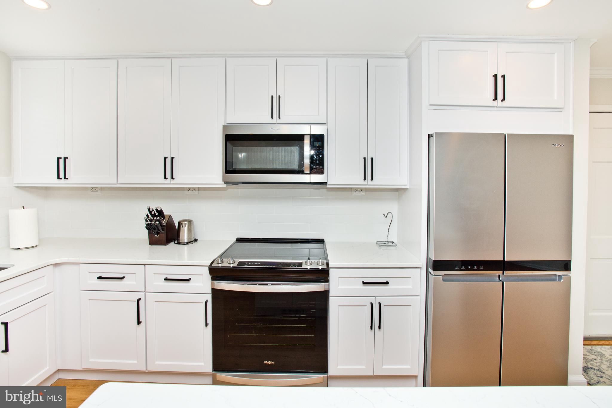 500 East Lancaster Avenue, Unit 135A Wayne, PA 19087 - Photo 11 of 24 a kitchen with stainless steel appliances a refrigerator stove and white cabinets