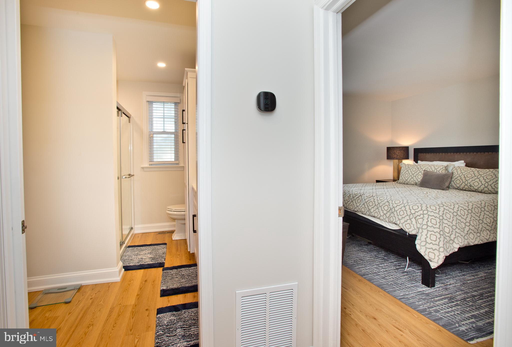 500 East Lancaster Avenue, Unit 135A Wayne, PA 19087 - Photo 14 of 24 a bedroom with a bed and wooden floor