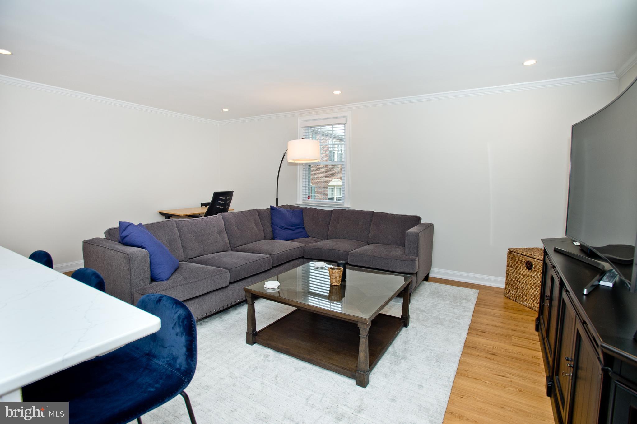 500 East Lancaster Avenue, Unit 135A Wayne, PA 19087 - Photo 7 of 24 a living room with furniture and a flat screen tv