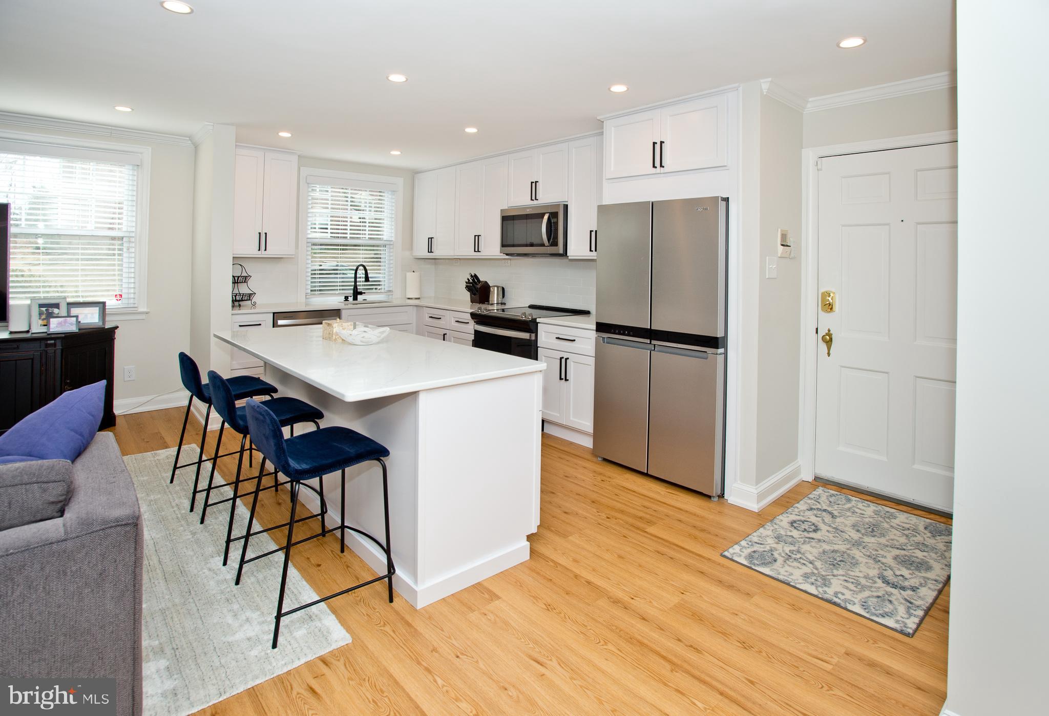 500 East Lancaster Avenue, Unit 135A Wayne, PA 19087 - Photo 10 of 24 a kitchen with stainless steel appliances a refrigerator stove microwave and cabinets