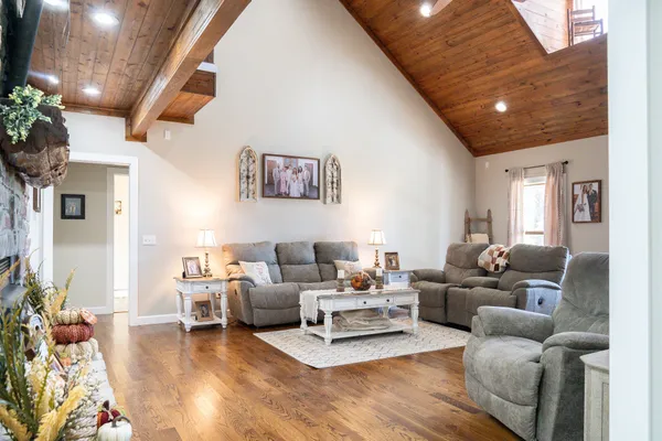 a living room with furniture and wooden floor
