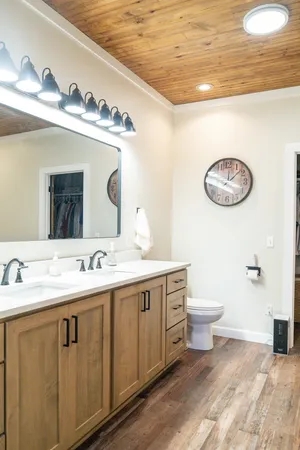 a bathroom with a toilet sink and mirror