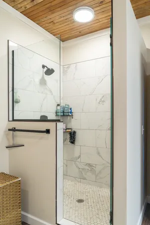 a bathroom with a shower and a sink