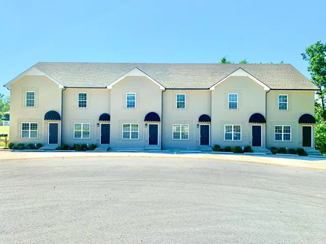 a front view of house with yard and trees