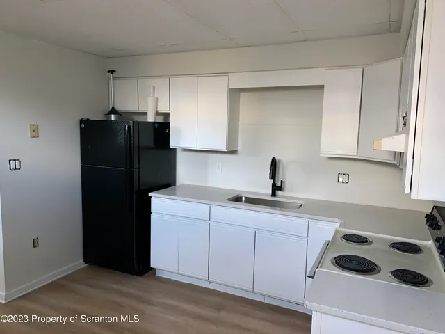 a kitchen with a sink and refrigerator